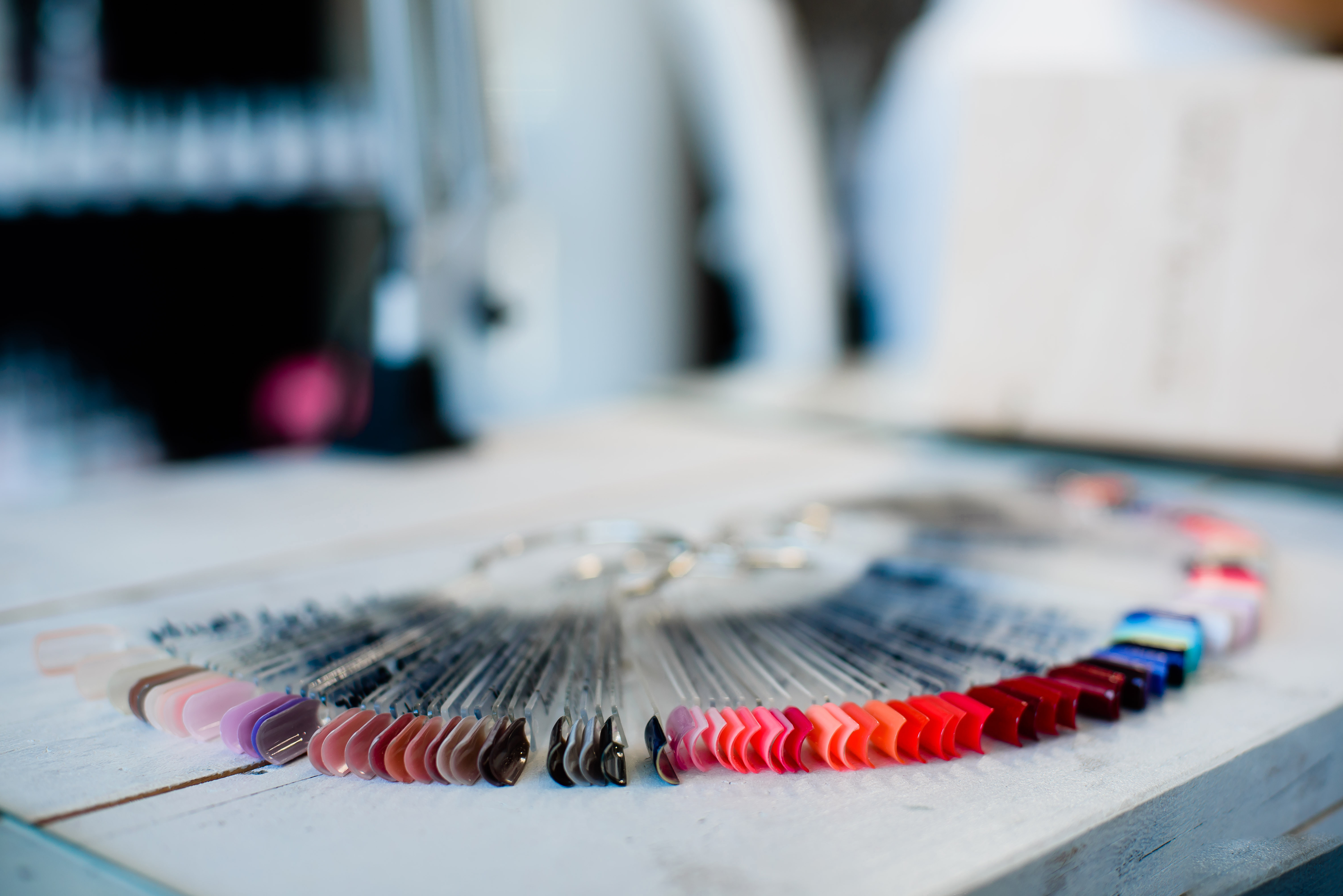 Close-Up Of Colorful Artificial Nails On Table At Store