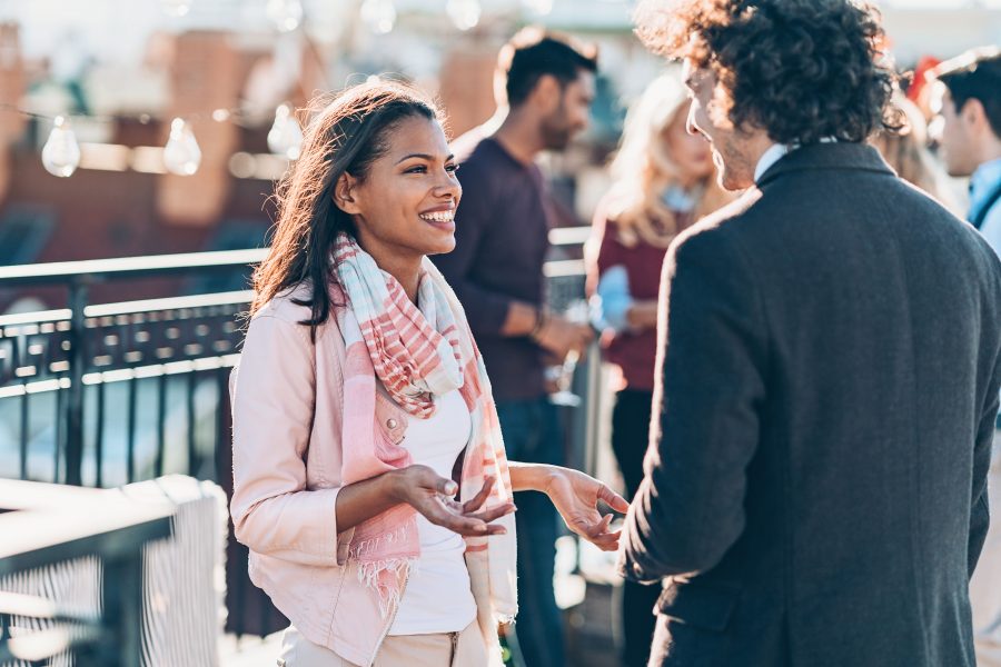 Couple talking on a rooftop gathering