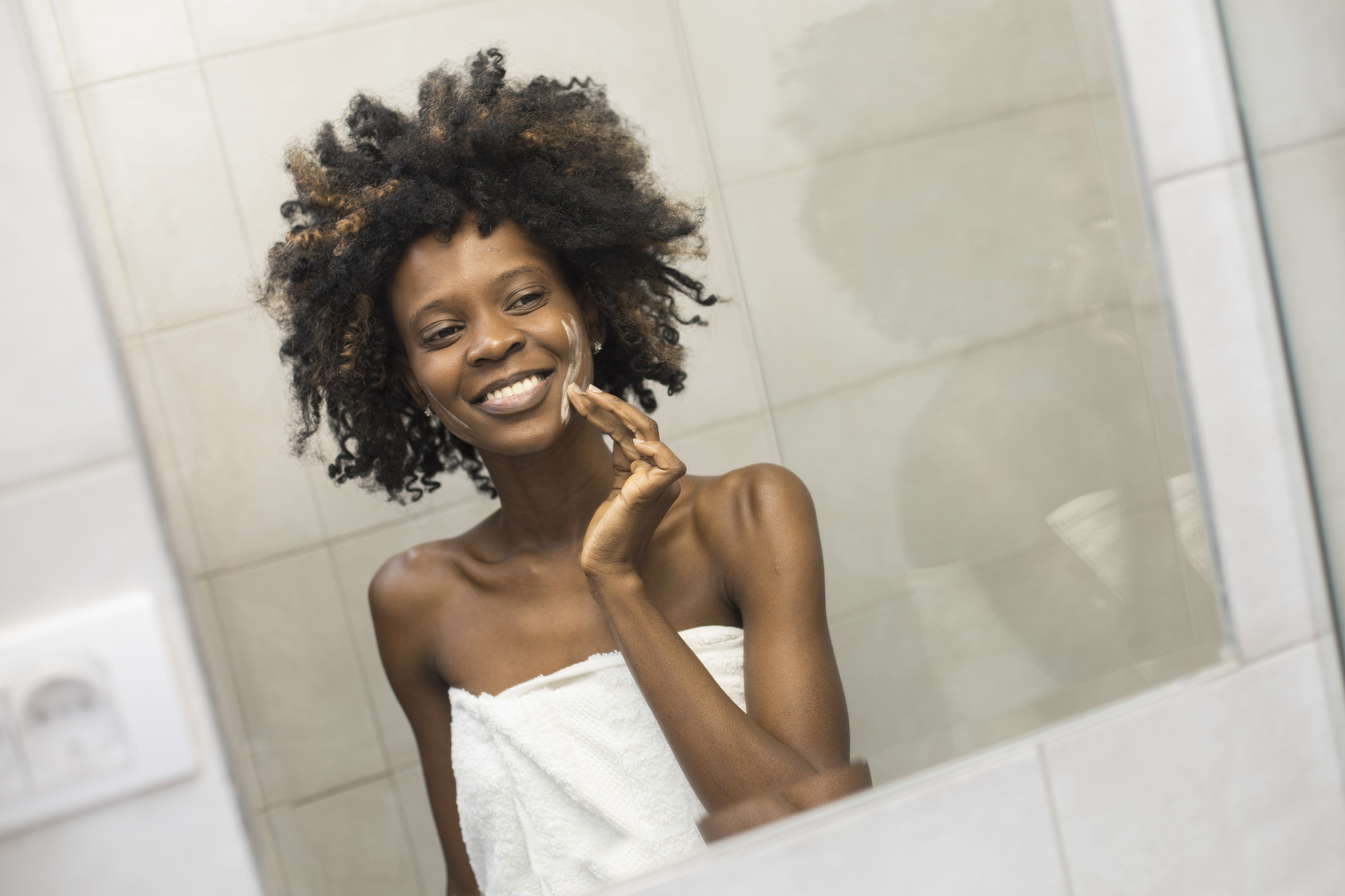 Young woman using ointment