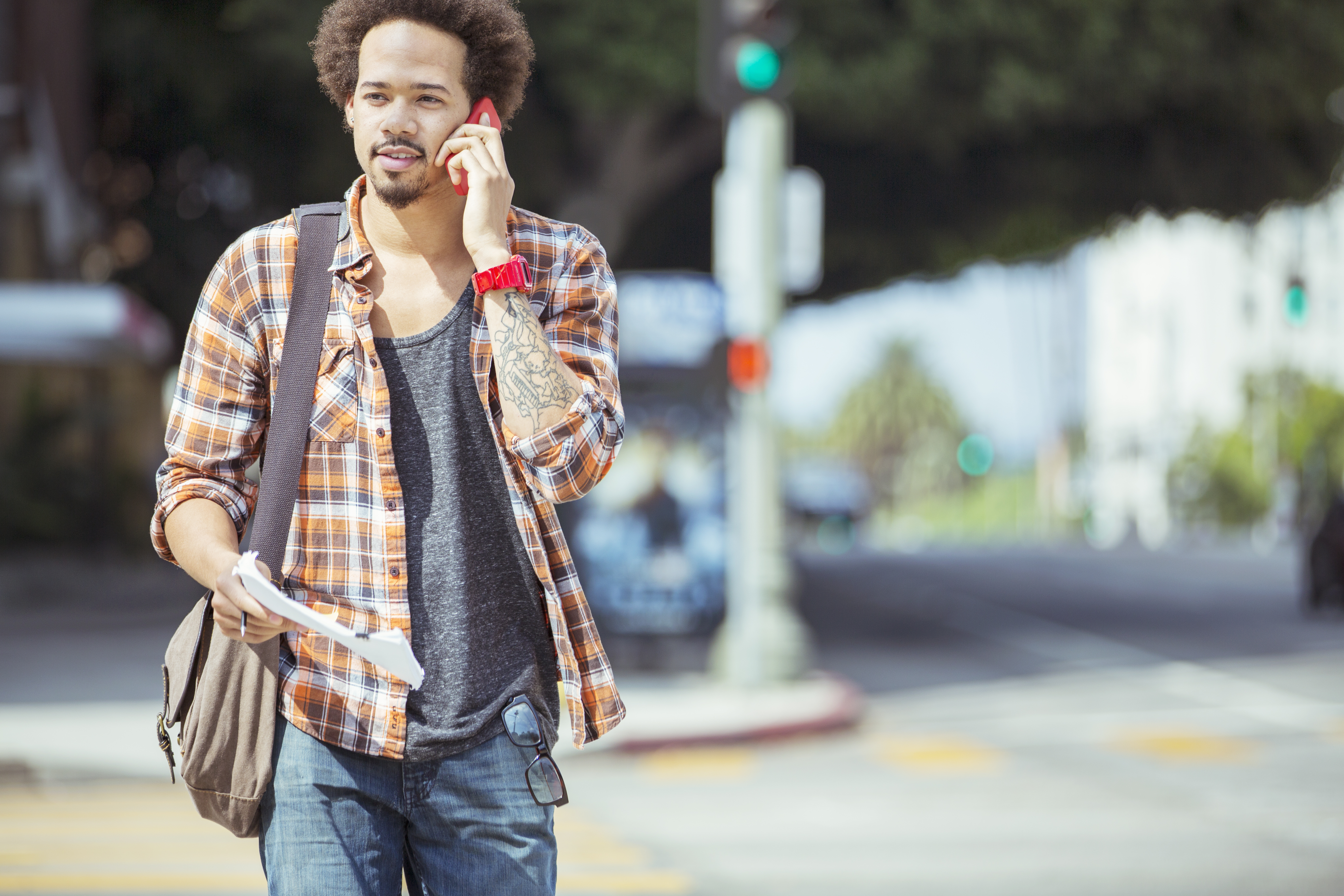 Man talking on cell phone in urban crosswalk