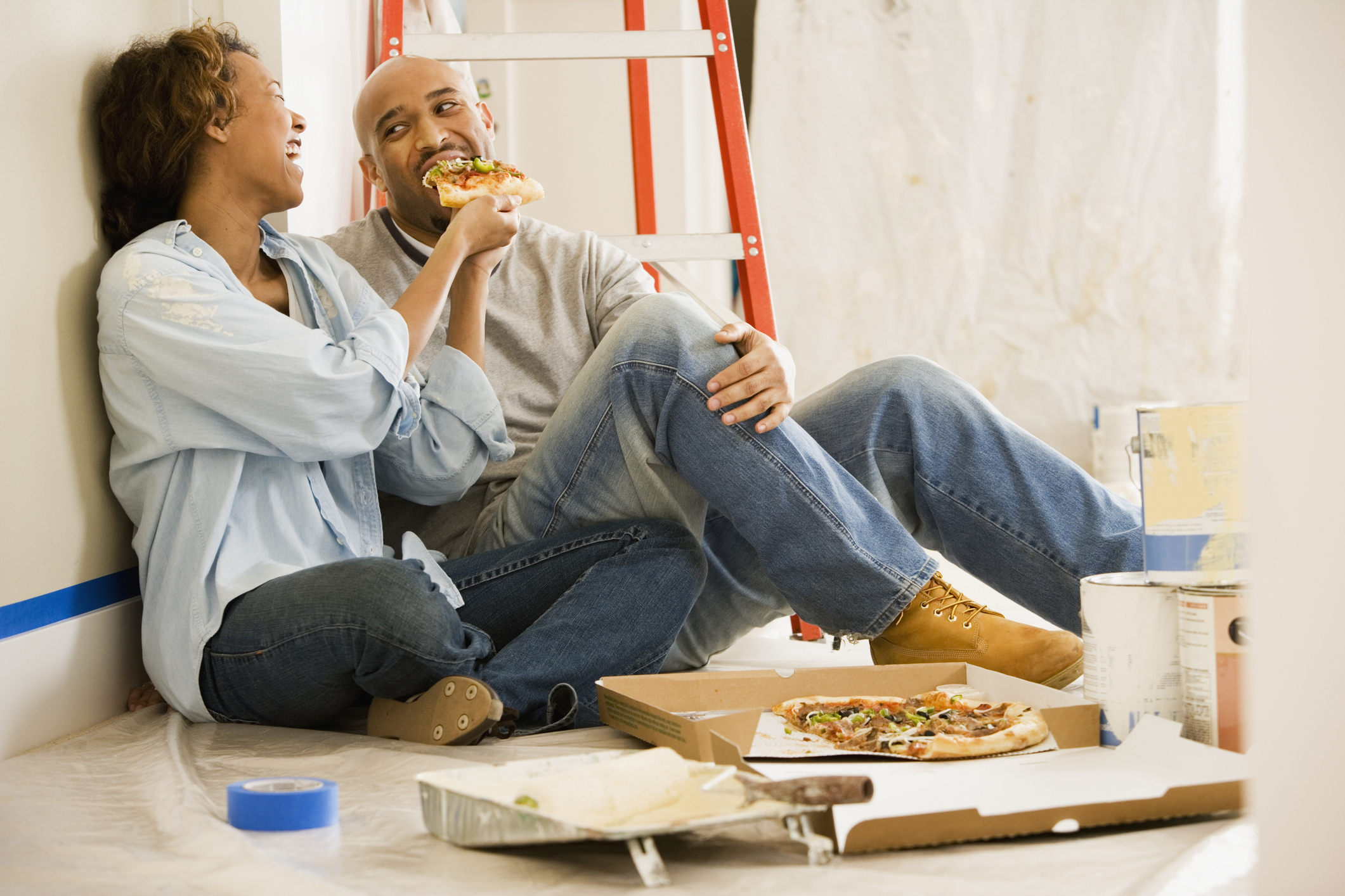 African couple taking lunch break from painting