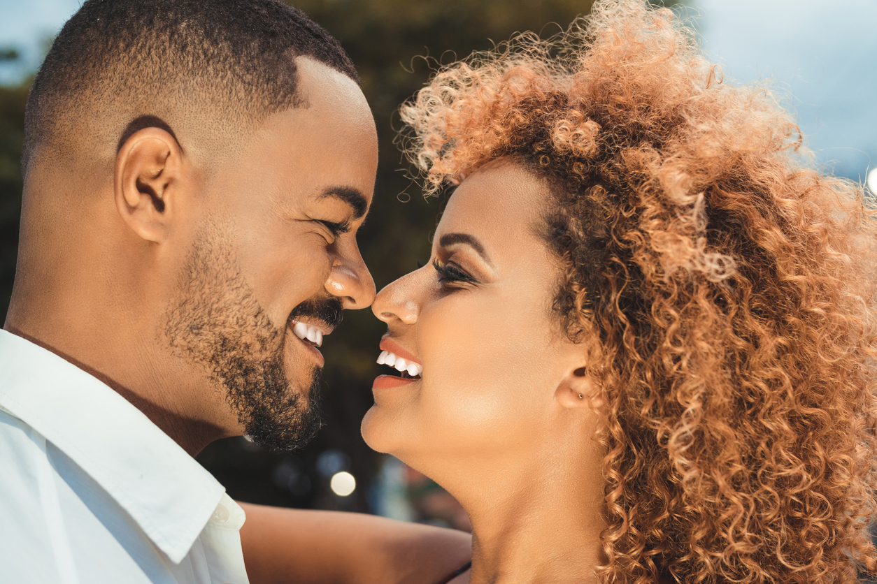 Afro couple kissing outdoors