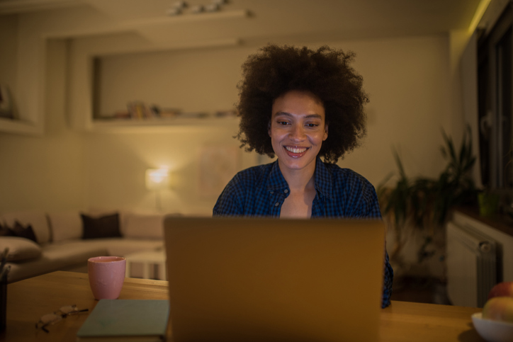 Smiling student using laptop