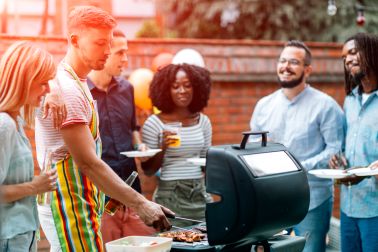 Young People Havin Fun At Barbecue Party.