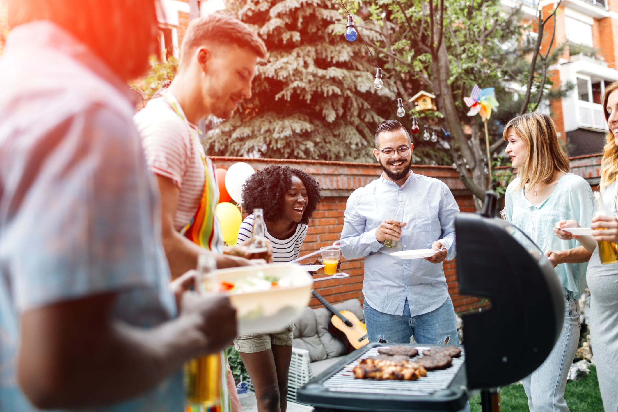 Young People Having Fun At Barbecue Party.
