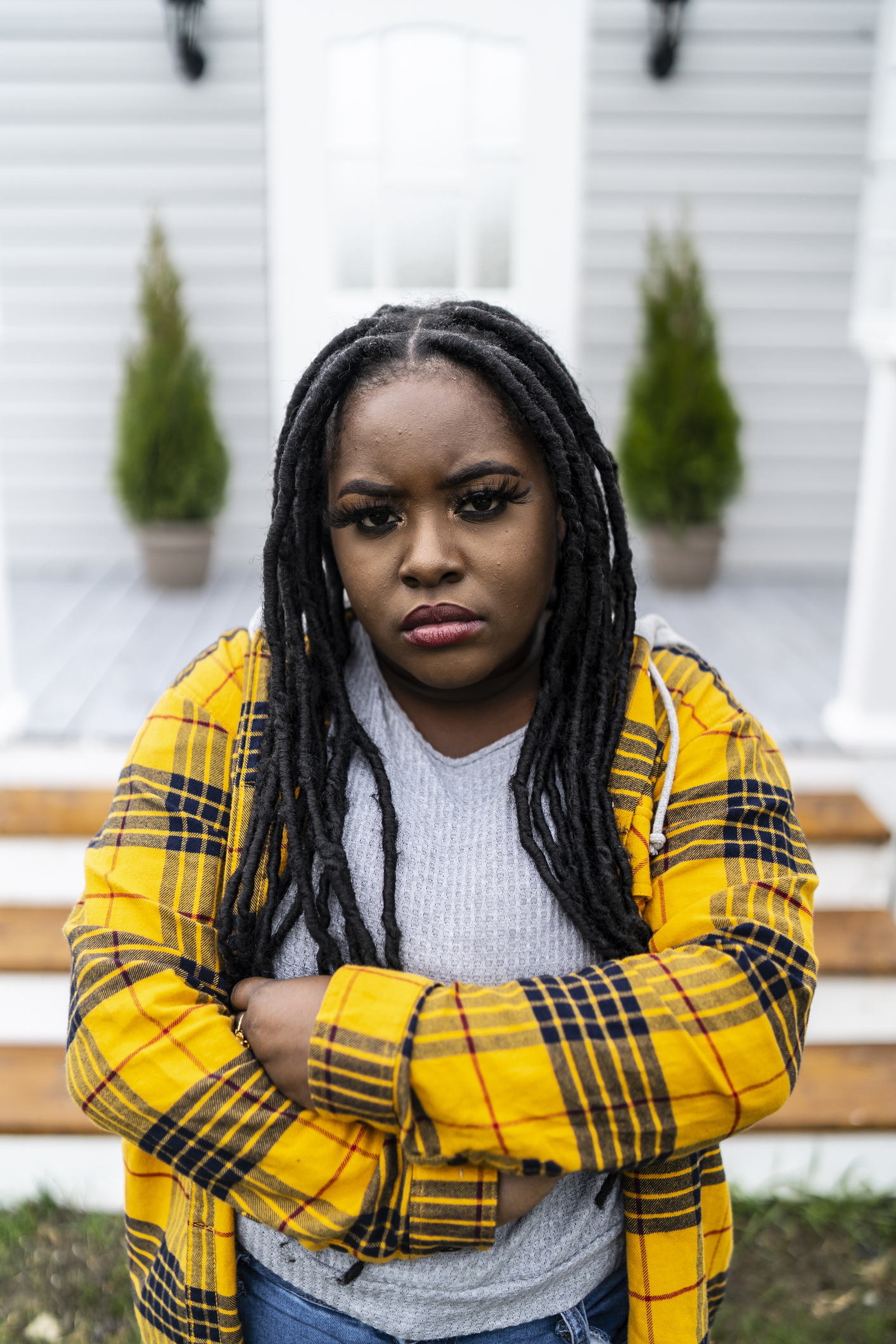 Young african woman standing arms crossed and looking at camera
