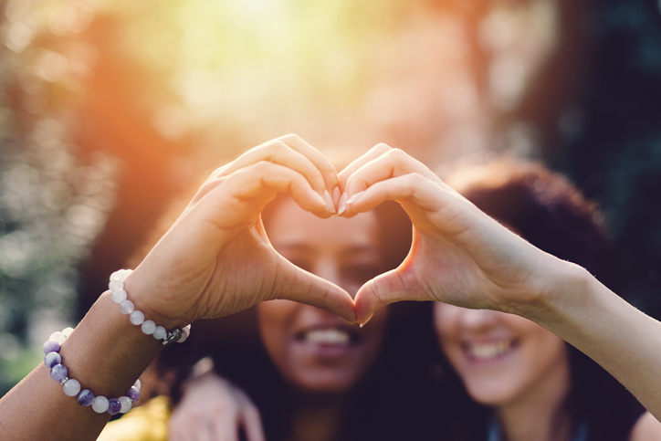 Girls making heart with hands