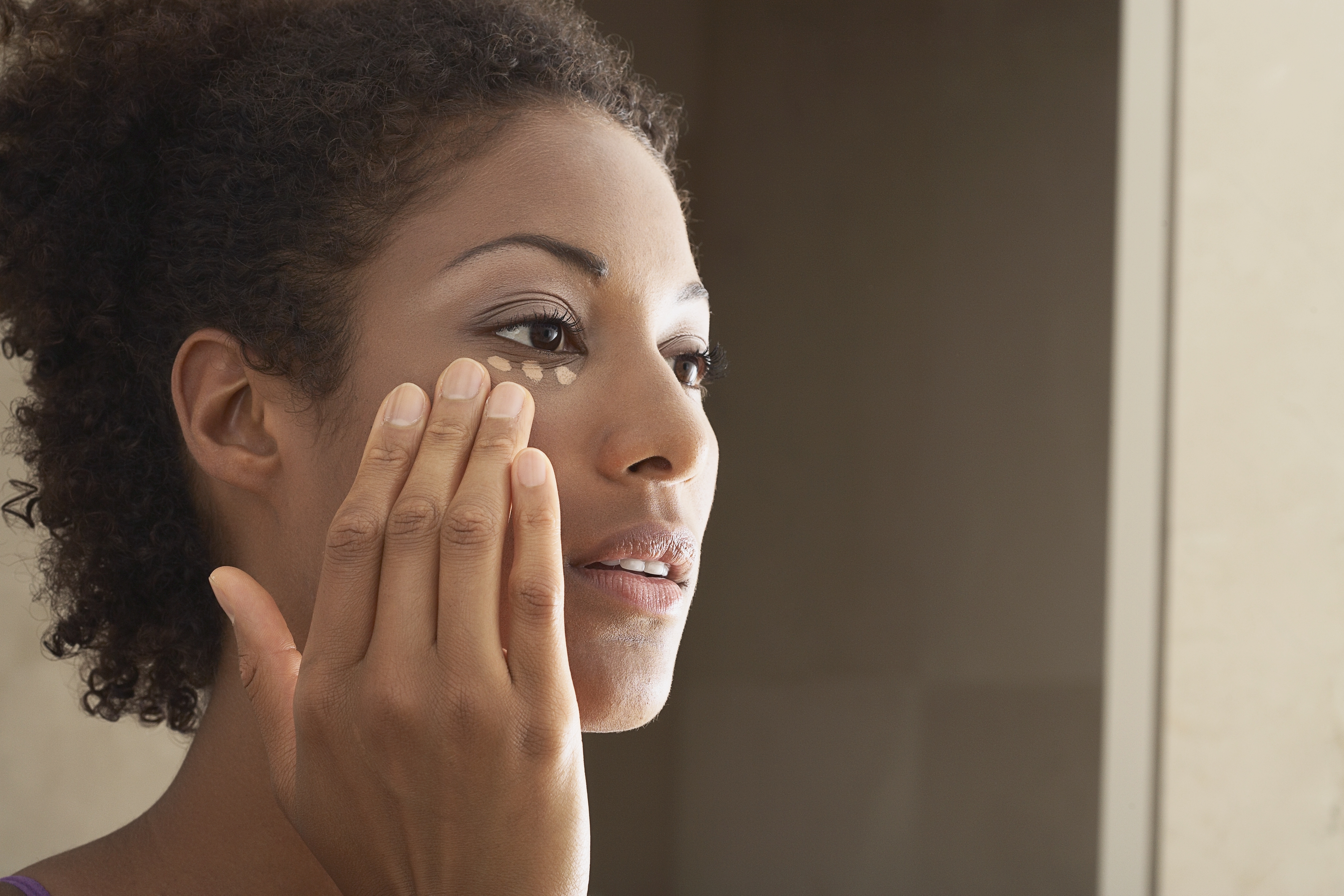 Woman Applying Makeup - stock photo