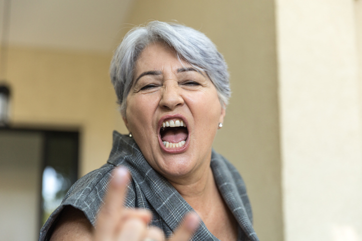 Senior Woman Giving a Horn Sign Portrait