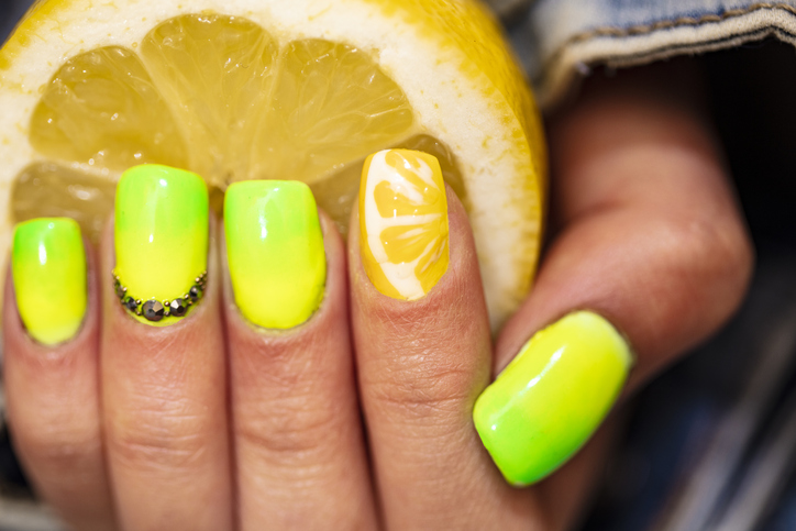 Close-Up Of Woman Fingers With Nail Art Manicure with neon colour