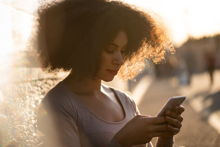 Bad news - young woman looking to phone