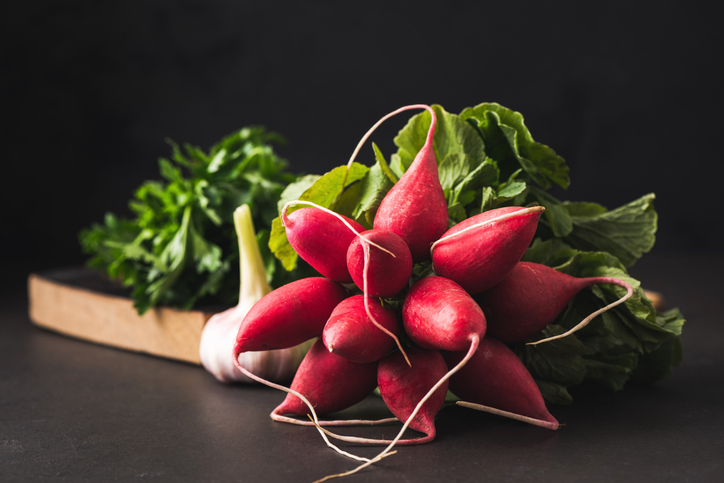 Fresh spring radish on black background