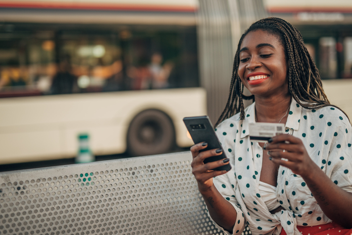 Lady sitting on bench and using phone