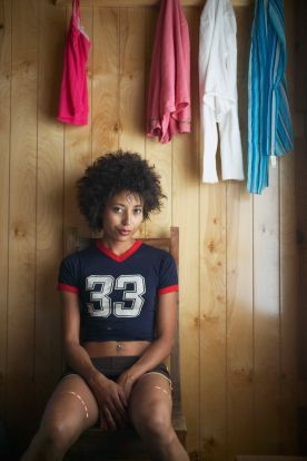 Moody young woman sitting alone