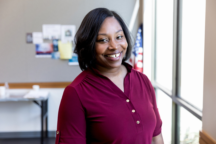 Mid adult female teacher poses for photo before class