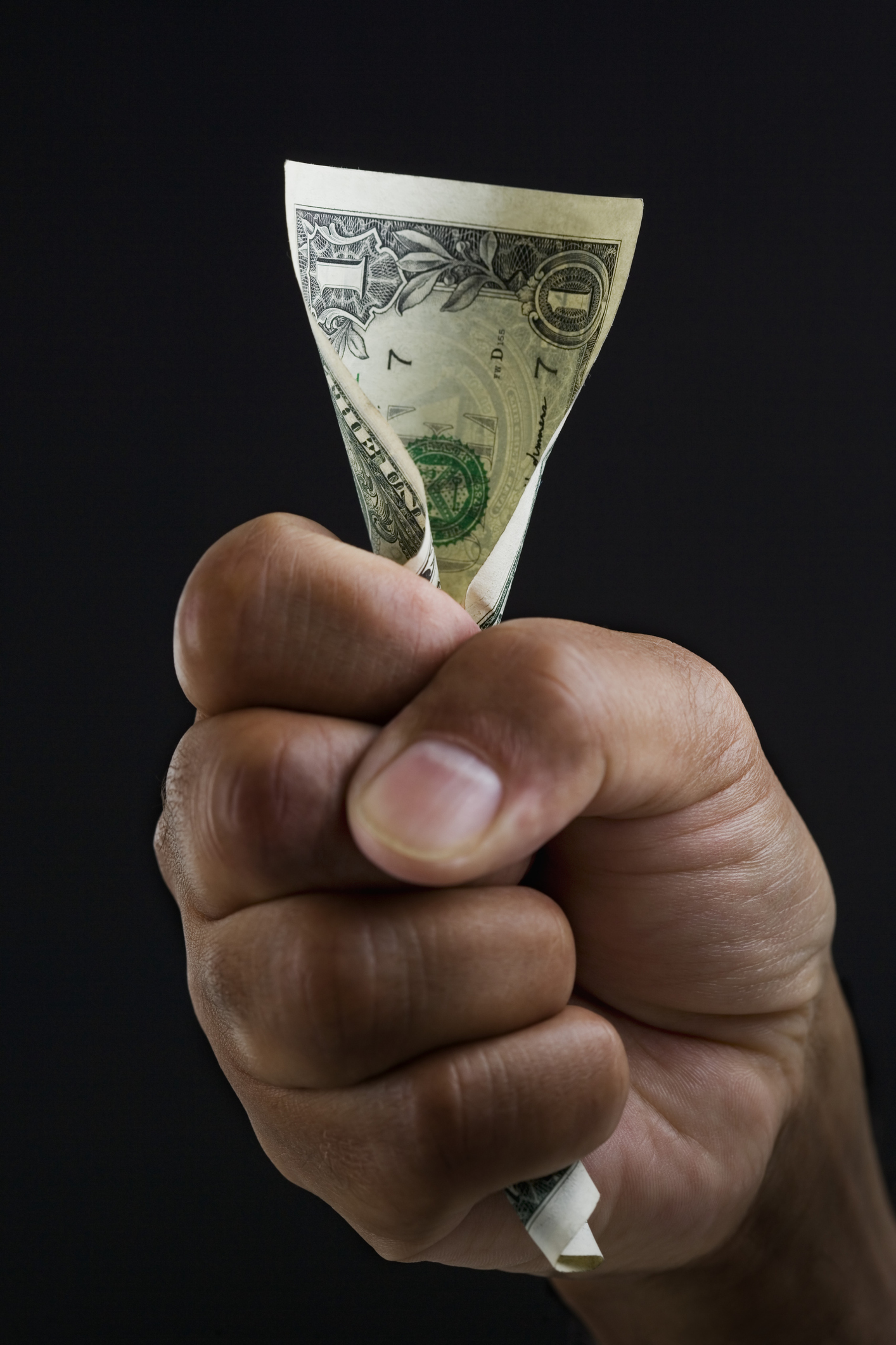 Close up of hand holding dollar bill