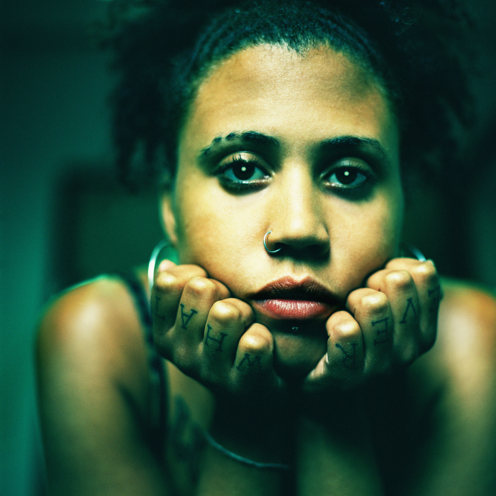Young Woman with "Whatever" Tattoo on Fingers
