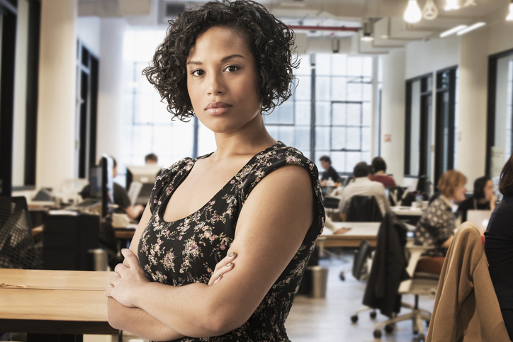 Mixed race businesswoman standing in office