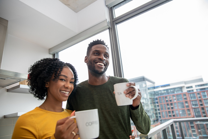 African American couple having a morning coffee together in the kitchen
