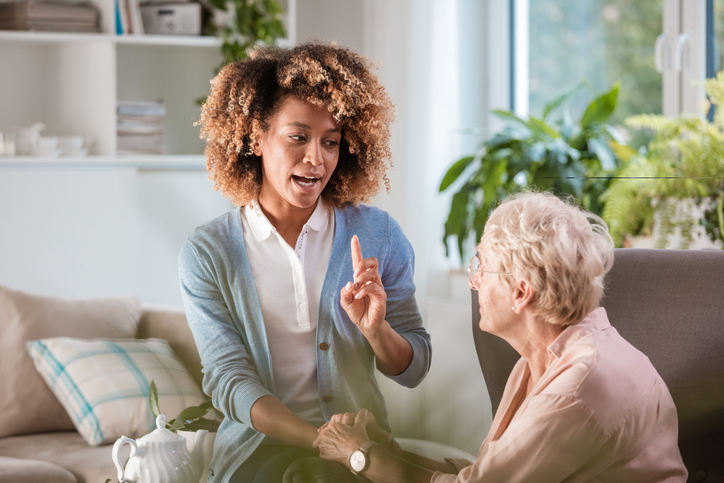 Home nurse talking with an eldery lady