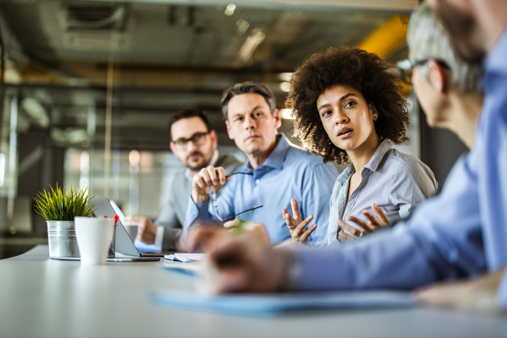 Black businesswoman talking to her colleagues on a meeting in the office.