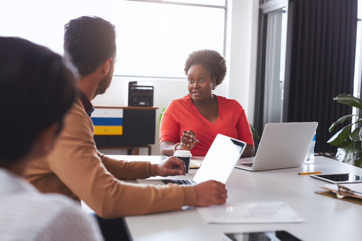 African American businesswoman talking with colleagues during an office meeting
