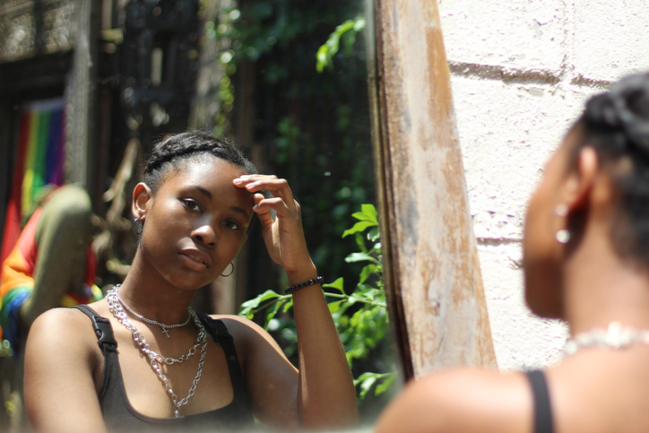 Reflection Of Teenage Girl In Mirror Standing Outdoors