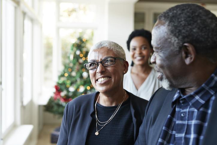 Close-up of smiling friends talking at home