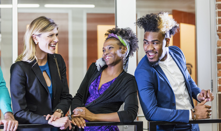 Three young business people standing together