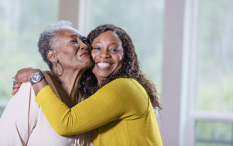 Senior African-American woman, adult daughter hugging