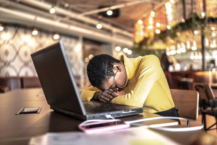 Tired young businesswoman working at office