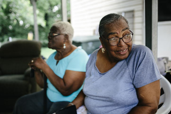 Two senior black women at family cookout
