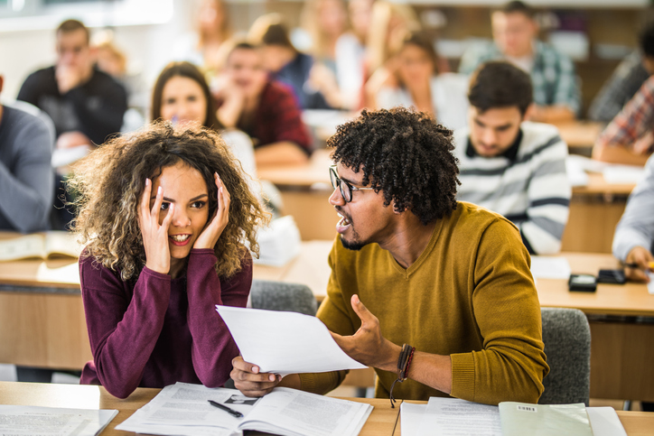 Frustrated college couple arguing on a class at school.