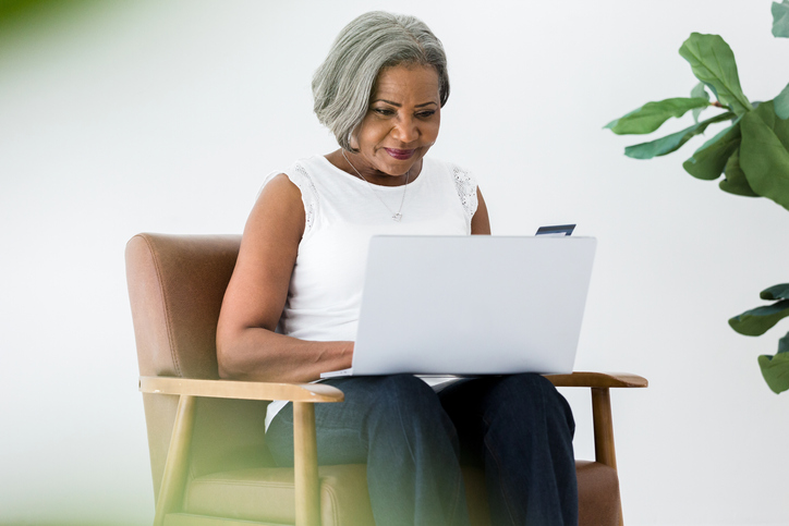 Confident business woman makes online purchase with company credit card