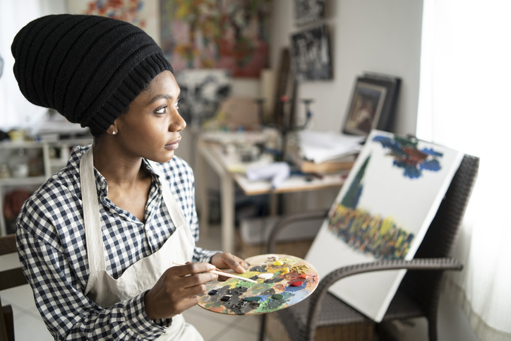 Beautiful fine art painter drawing in studio