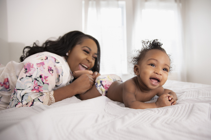 African American mother loving their baby daughter at home in Flushing, NY