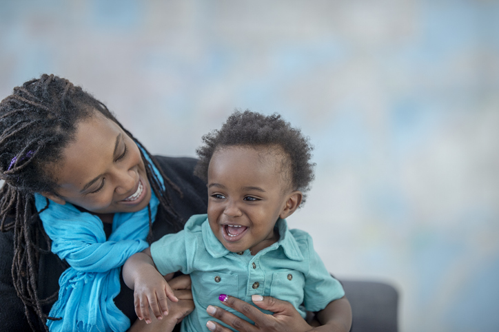 Mother and toddler son having fun together