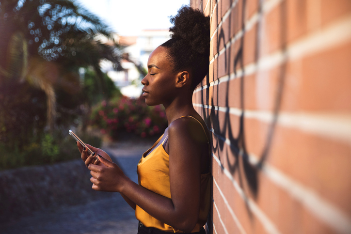 Pensive woman receiving a bad news on mobile