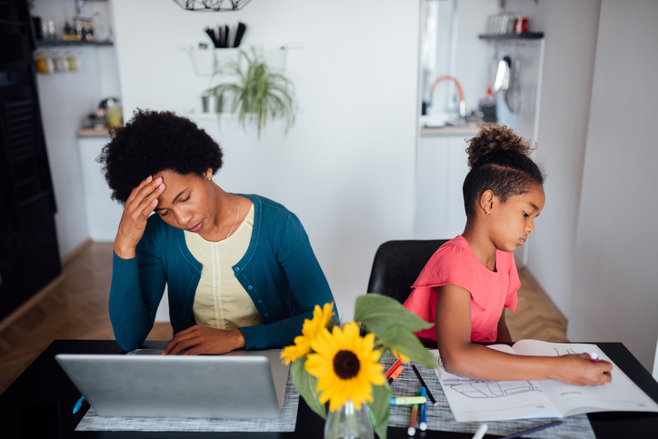Young African American mother looking for a job using internet