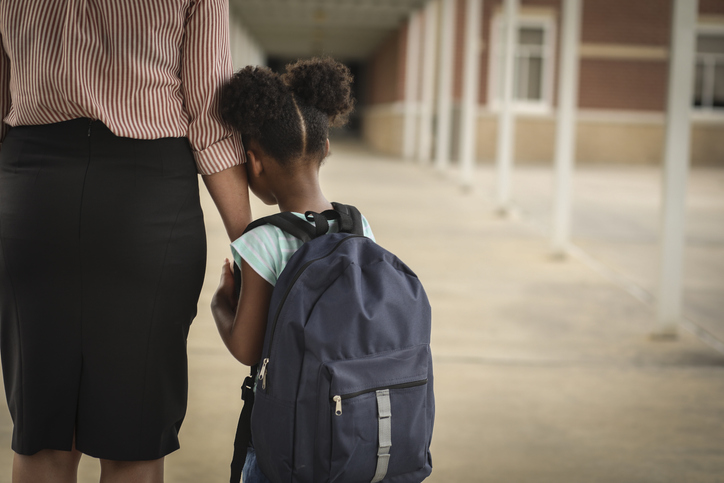 Elementary, African American girl with mom on first day of school.