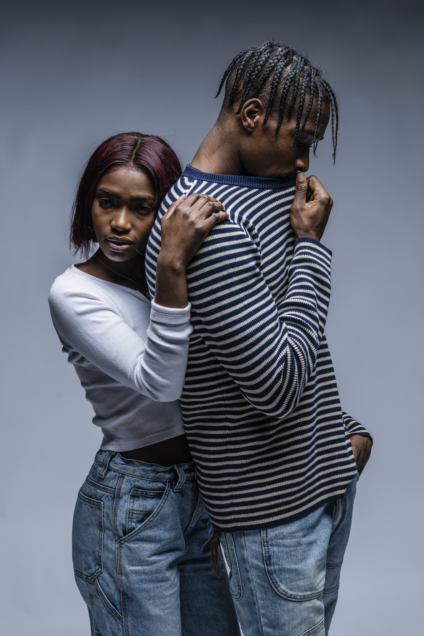 Young couple on grey background