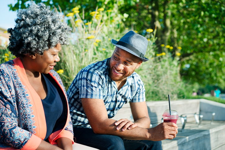 Man and woman sat talking and smiling