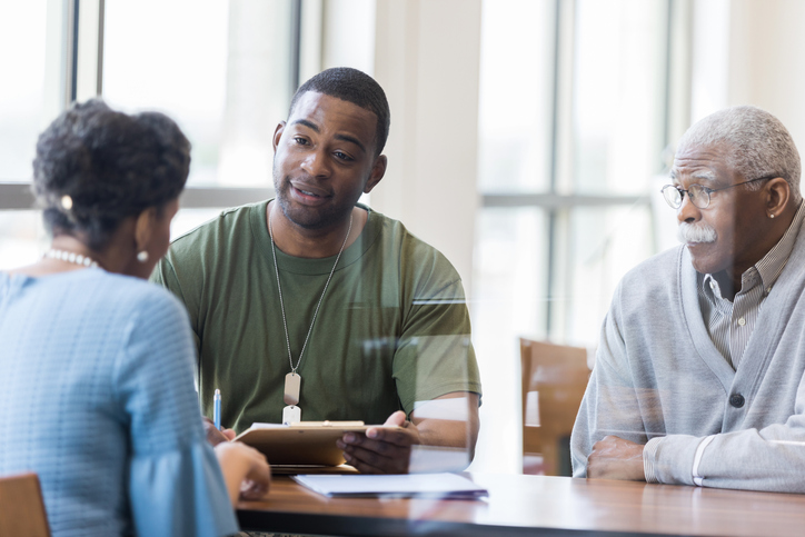 Father observes as army soldier son discusses loan