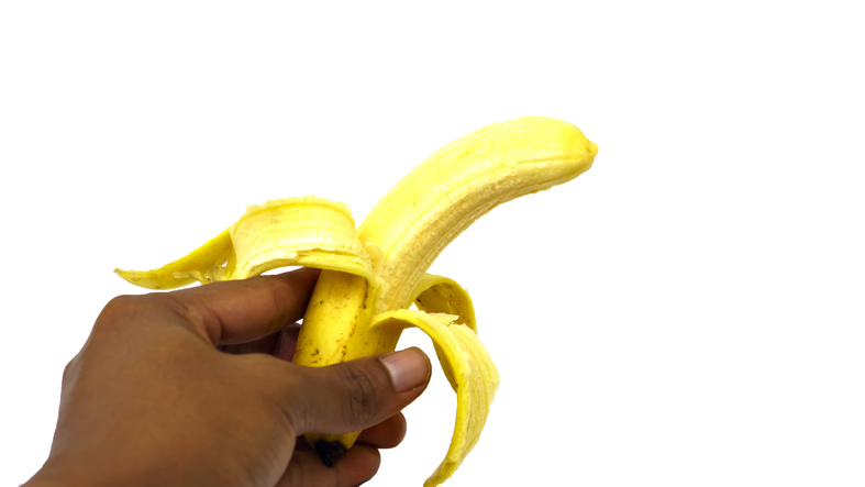 Close-Up Of Woman Holding A Banana