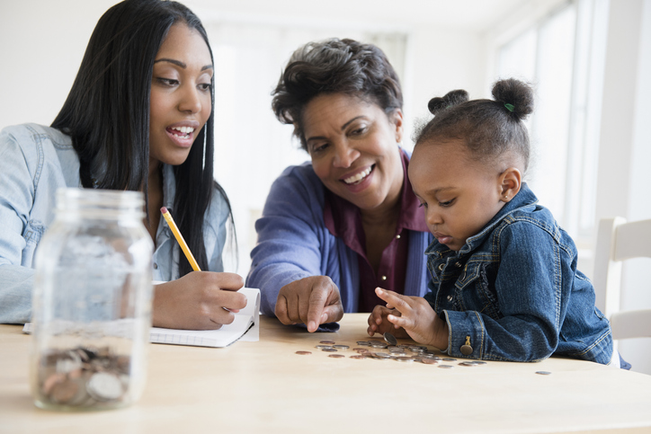 Black multi-generation family counting coins
