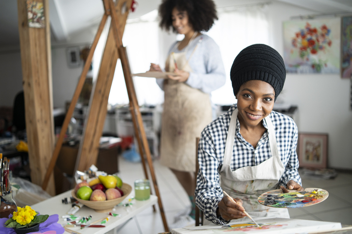 Female fine artists drawing in studio
