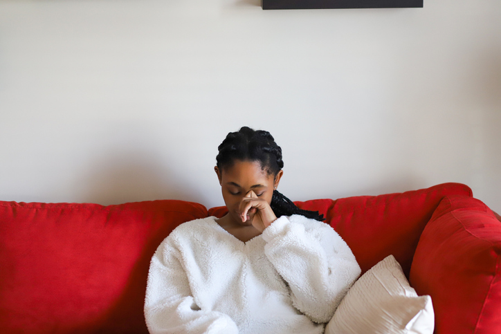 Young Woman Sitting On Sofa