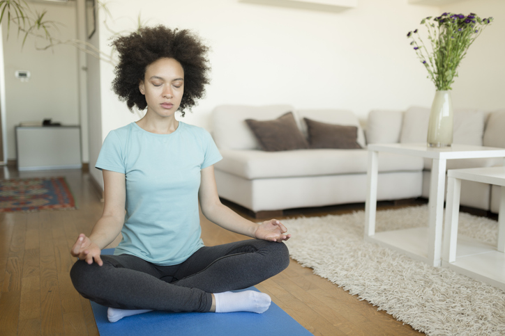 Front view of a serene young African American woman meditating