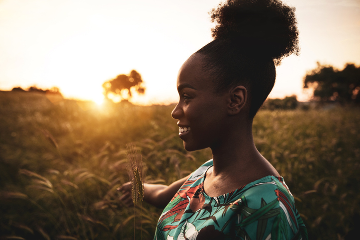 Woman with open arms breathing in the nature