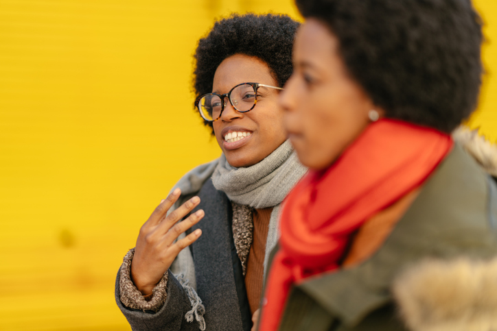black woman hugging her friends